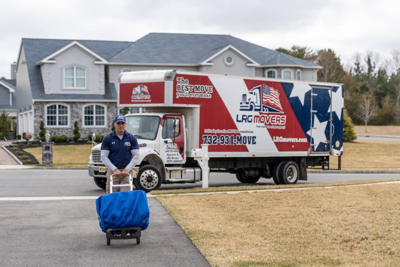 An LRG mover transporting a box. In the background is an LRG removal truck.