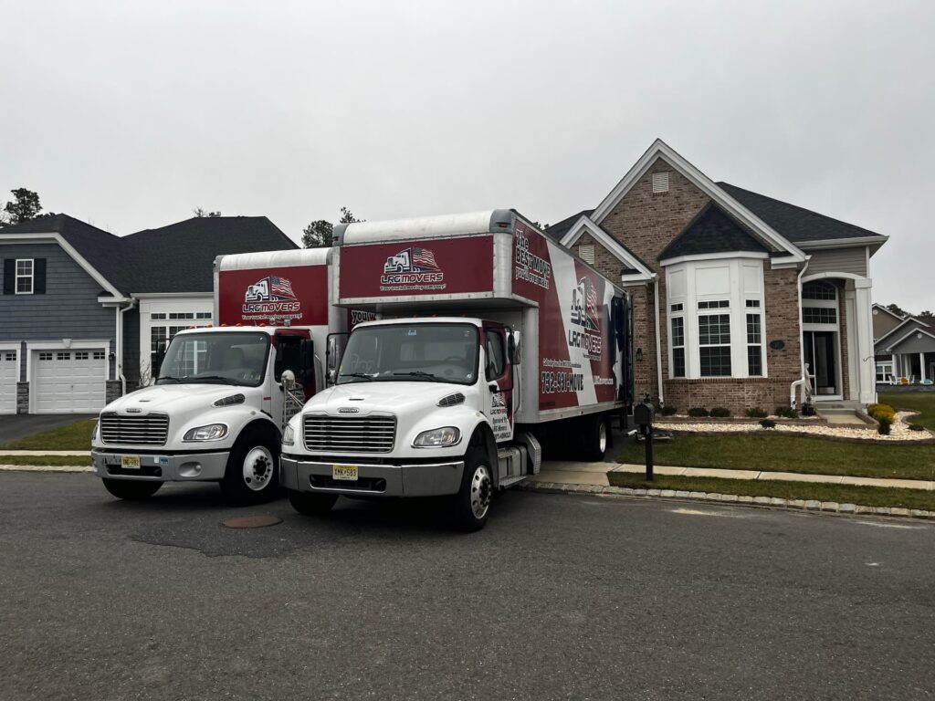 Two LRG Movers removal trucks outside a house.