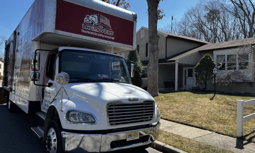 An LRG Movers removals truck outside a house.