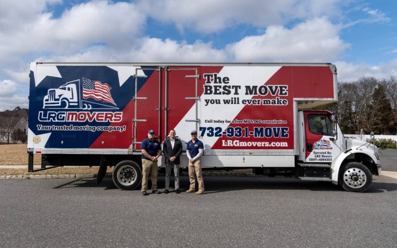 The LRG team in front of a large removal truck.