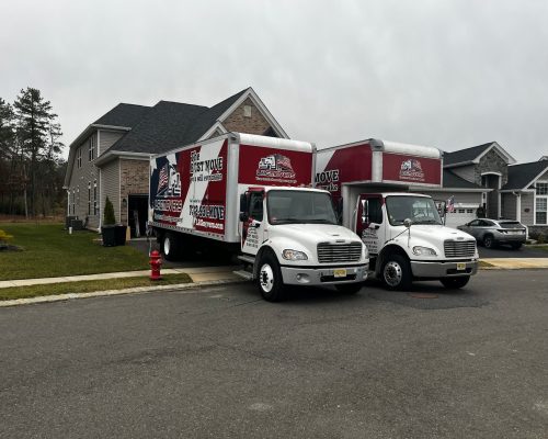 Two LRG Movers removal trucks outside a house.